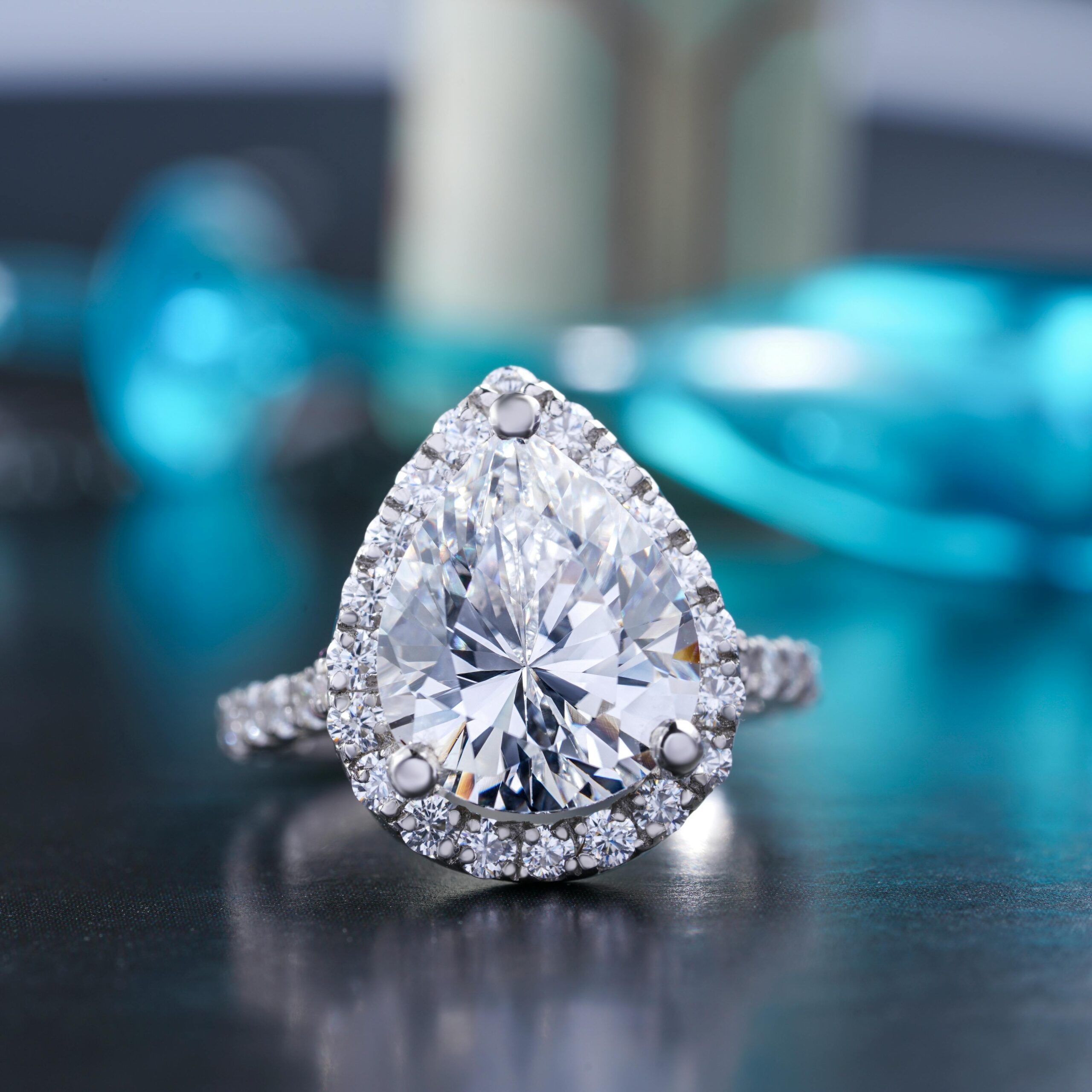 Close-up of a stunning teardrop diamond ring with a silver band, showcasing elegance and luxury.